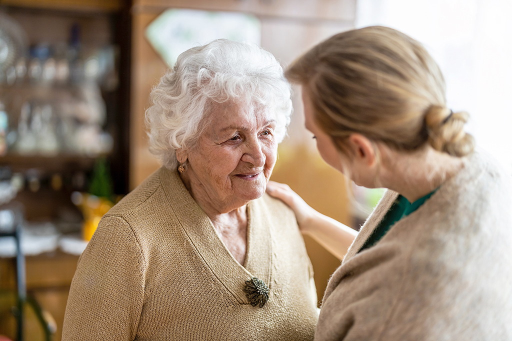 Health visitor talking to a senior woman during home visit Photo of health visitor talking to a senior woman during home visit