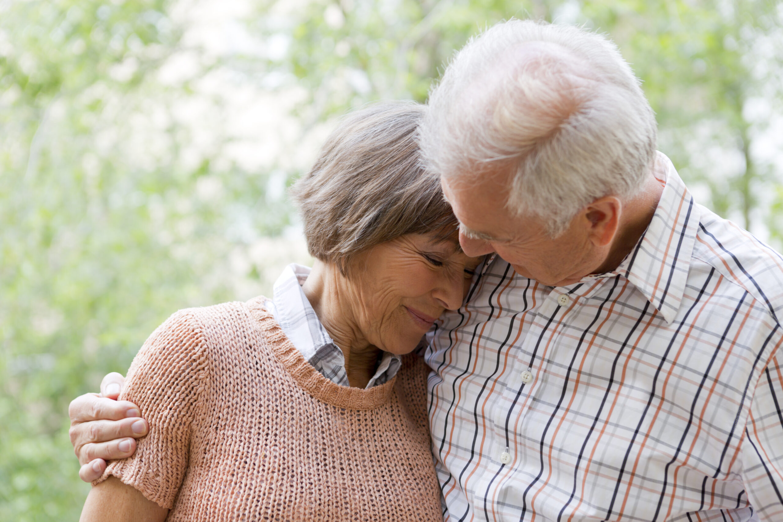 Senior couple smiling and hugging