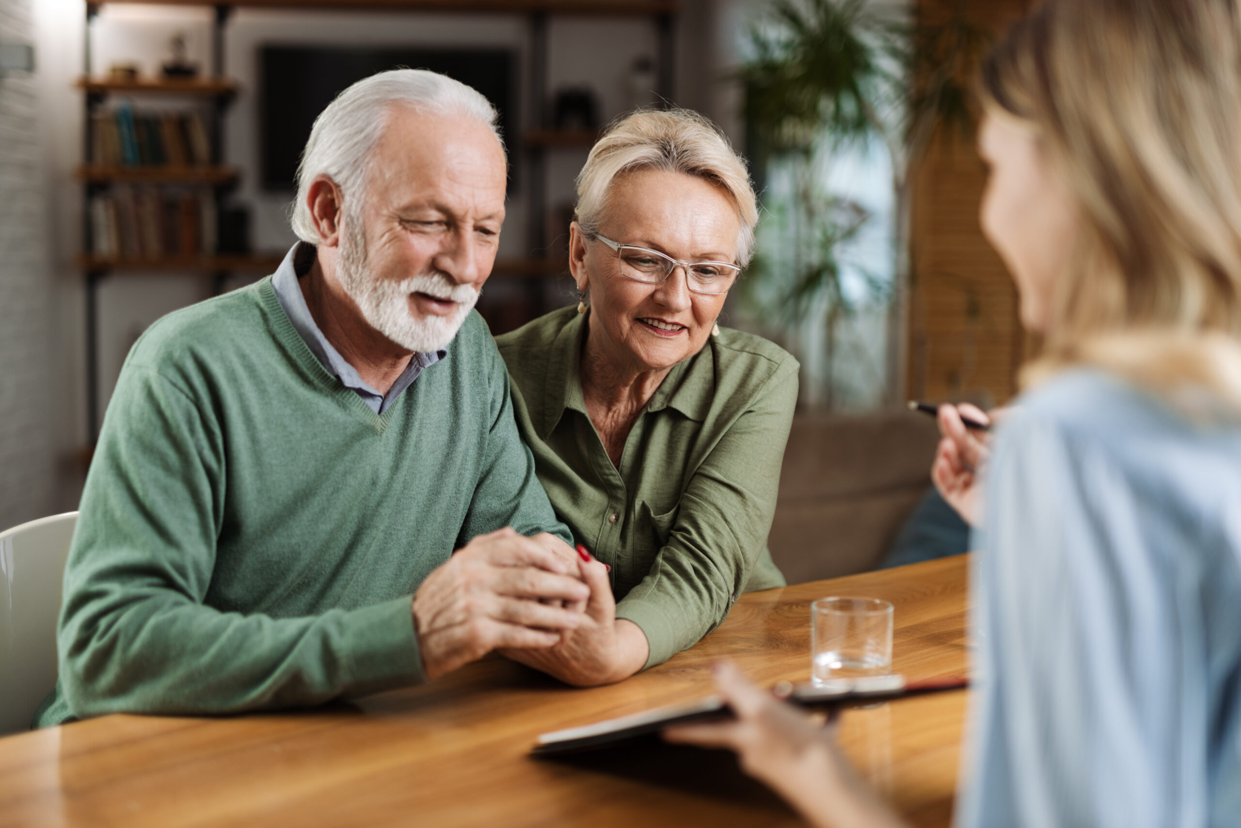 Photo of young woman helping elderly grandmother with paperwork